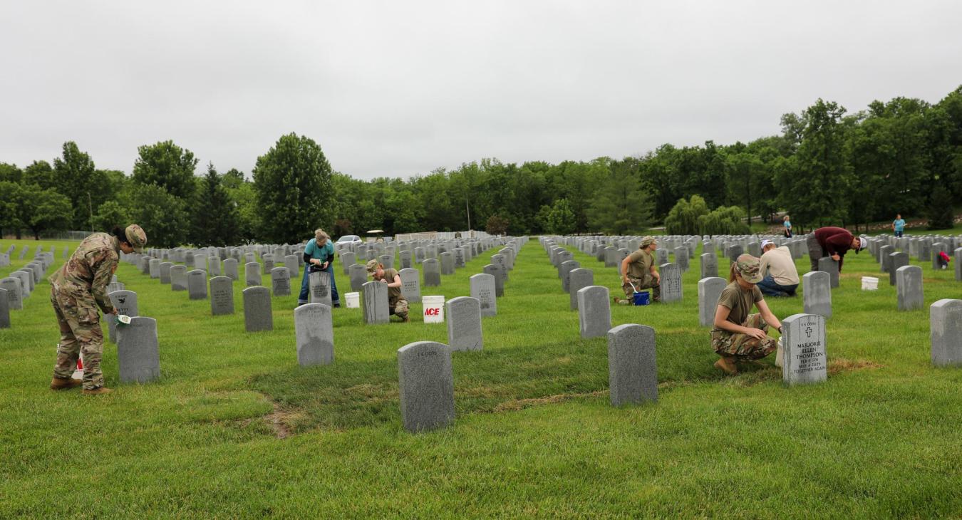 group cleaning headstones