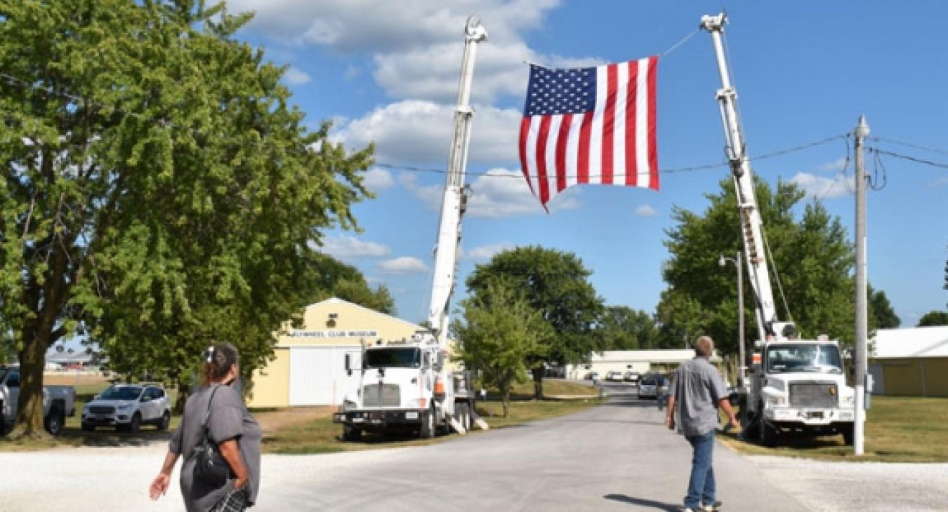 A flag flying between two cranes